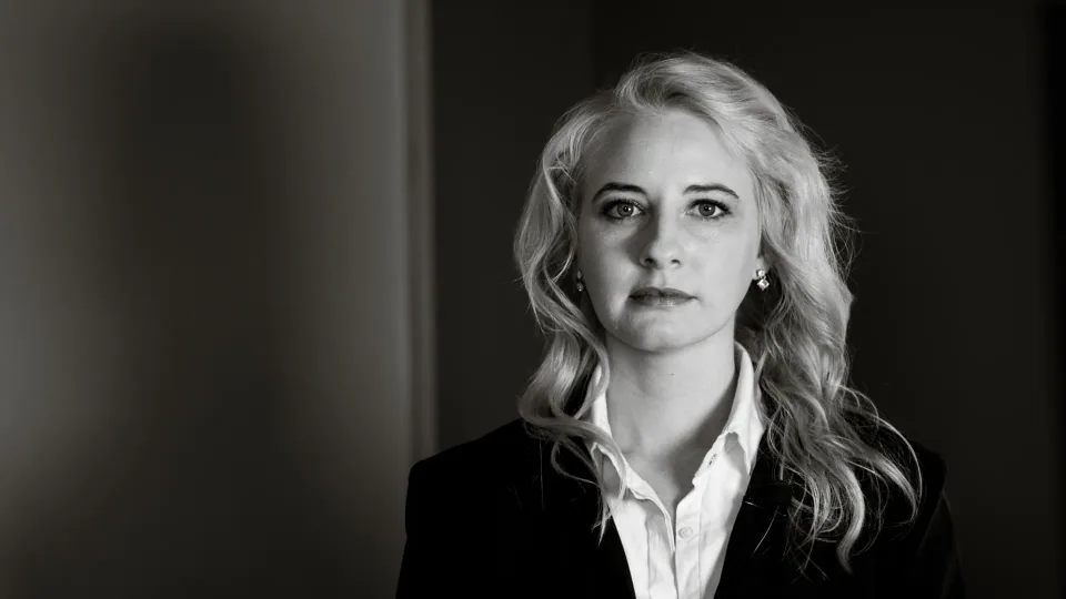 Black and white portrait of a woman in a blazer.