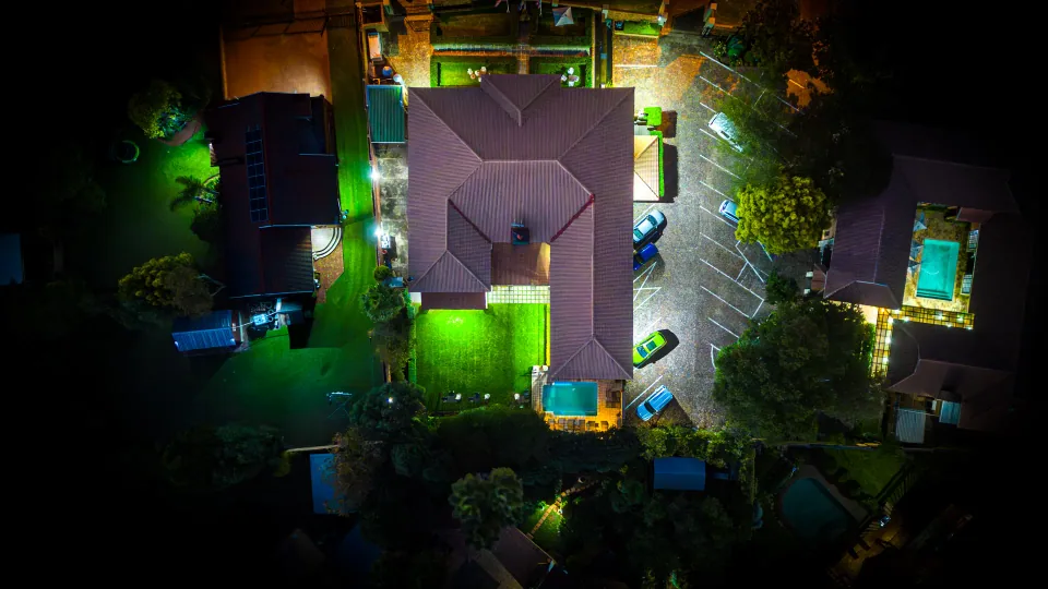 Aerial photograph of an illuminated building and grounds at night.